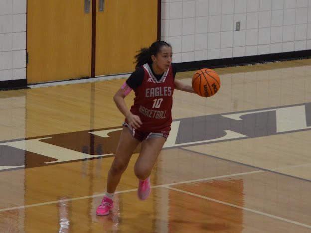 Naima pushing the ball up the court in transition