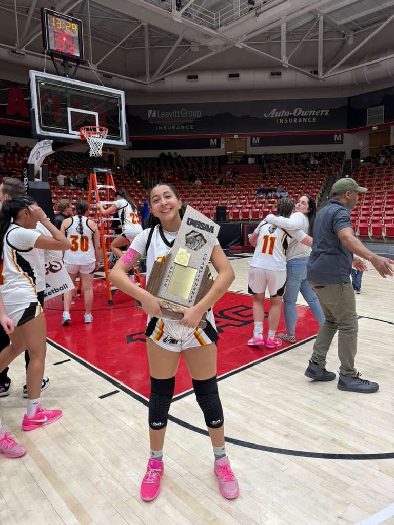 Naima holding the UHSAA state championship trophy